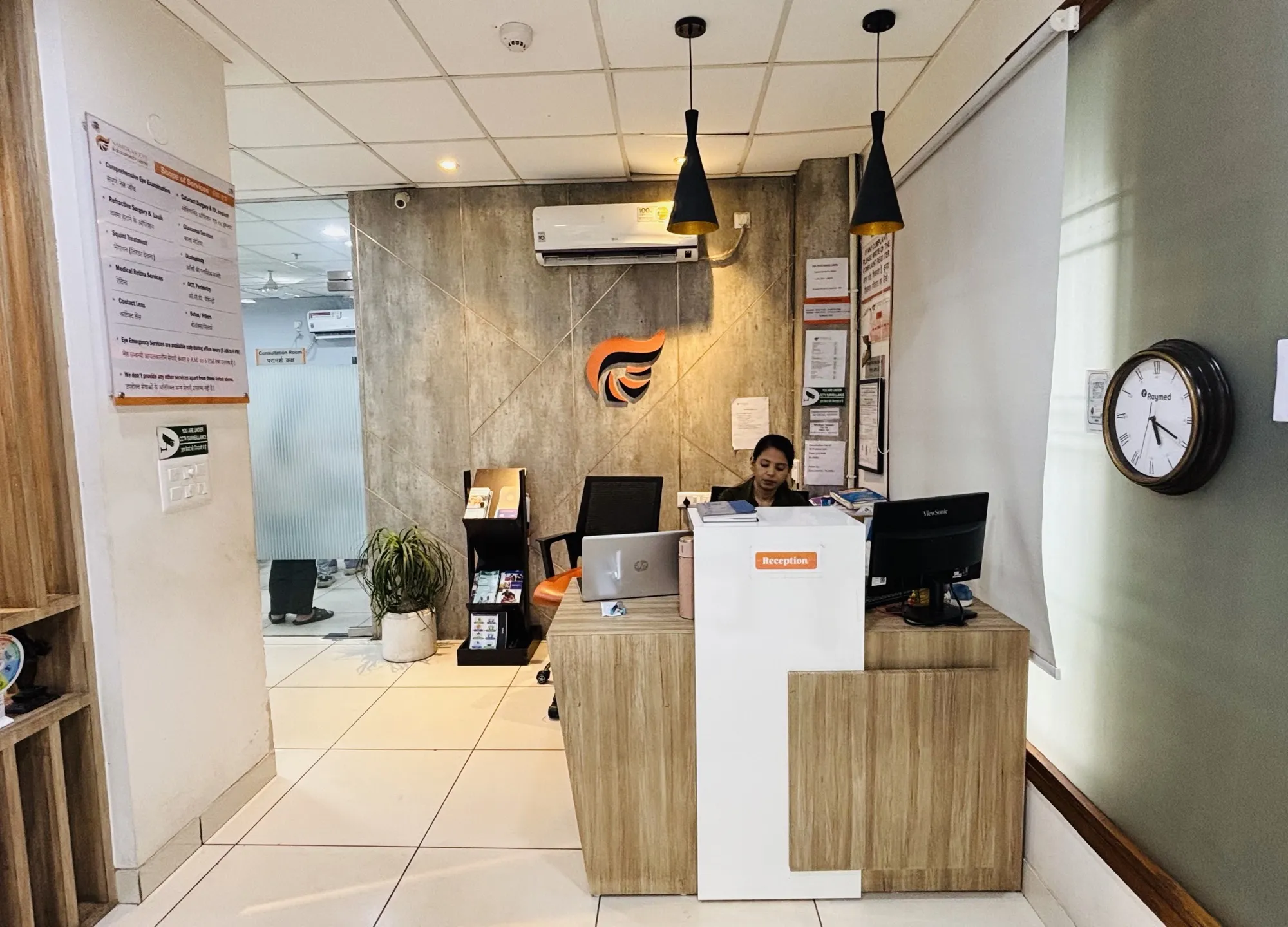 The reception area at Namokar Eye & Oculoplasty Centre, with the Namokar logo on the wall behind the desk